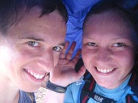 Chris Rycroft and Becky Hopkinson taking shelter from the rain atop the Bondcliff summit