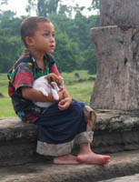 Cradling a puppy near Angkor Wat