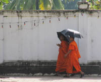 Buddhist monks pass near the Presidential Palace